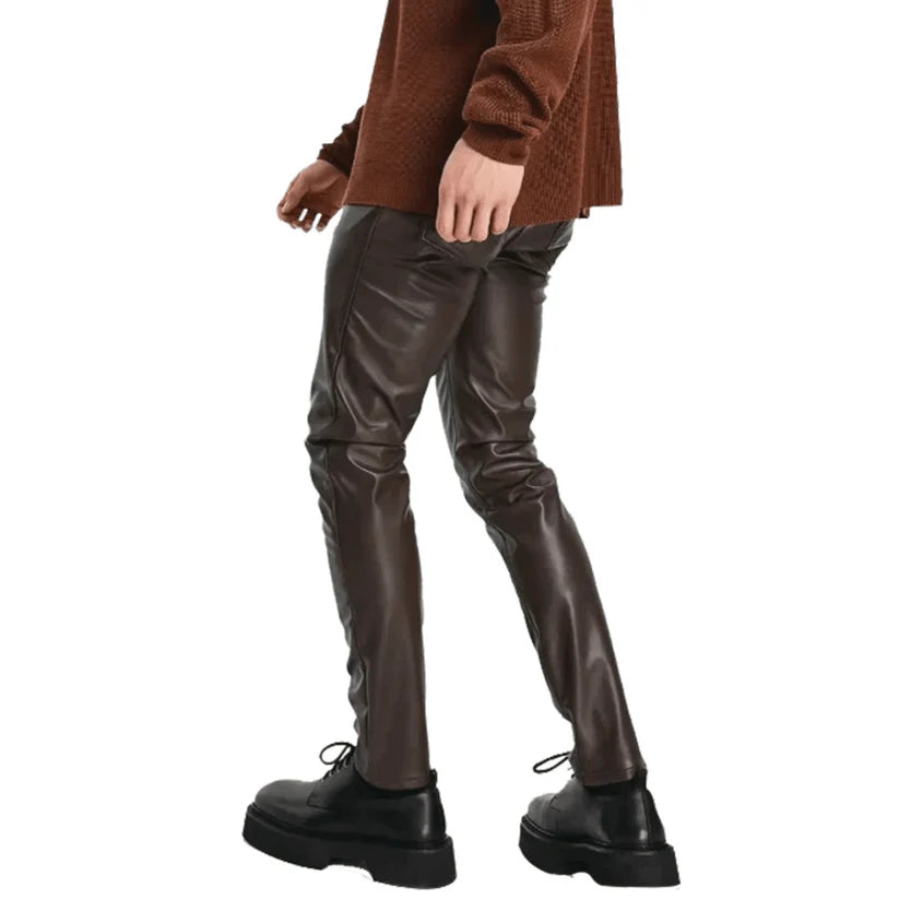 Brown leather pants worn by a person on a white background
