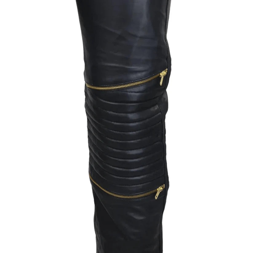Black leather leggings with gold zippers on a white background