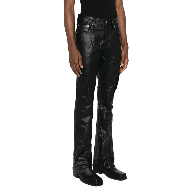 Person wearing black leather pants on a white background