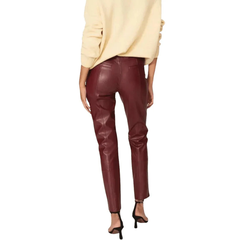 Maroon leather pants worn by a person on a white background