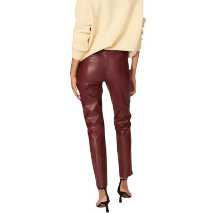 Maroon leather pants worn by a person on a white background
