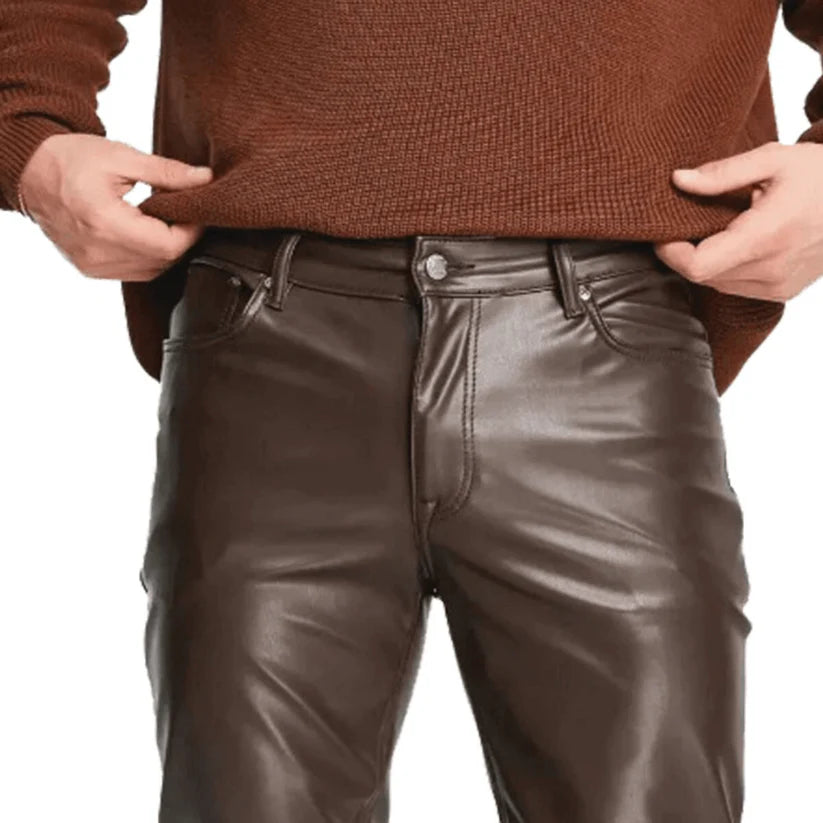 Brown leather pants worn by a person on a white background