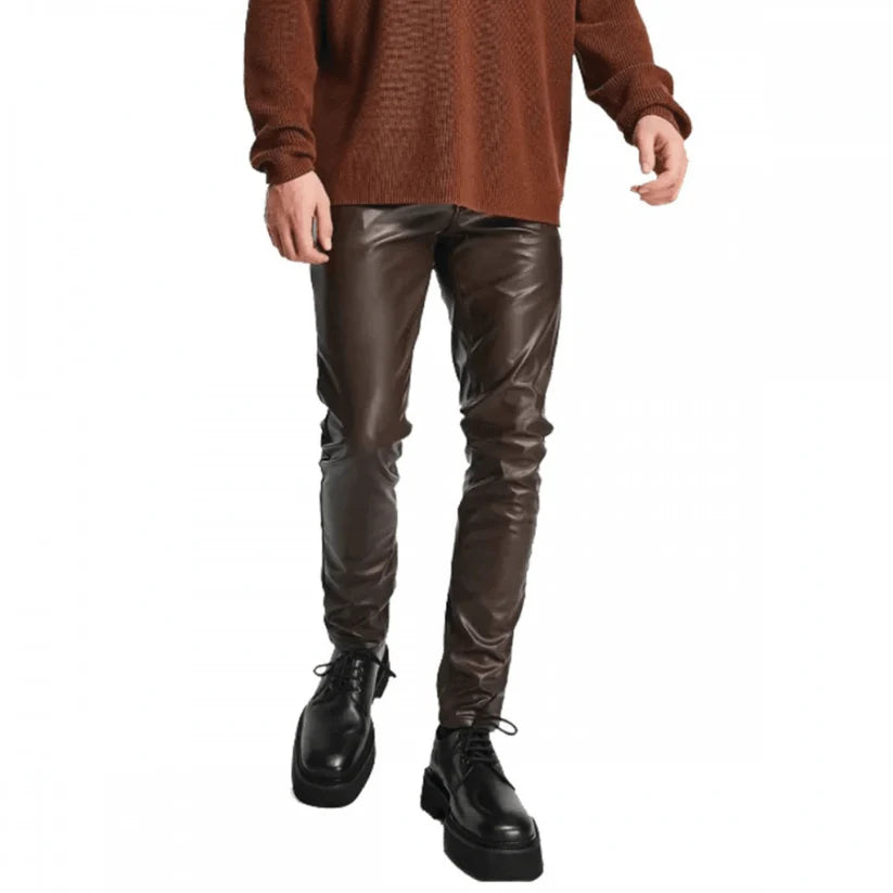 Person wearing brown sweater and leather pants on a white background