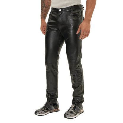 Person wearing black leather pants on a white background