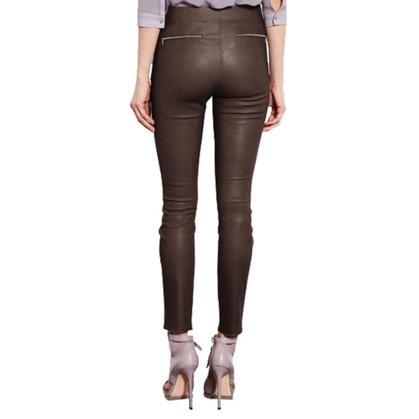 Brown leather pants worn by a person on a white background