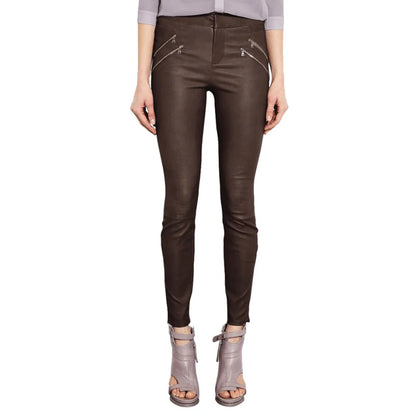 Brown leather pants worn by a person on a white background