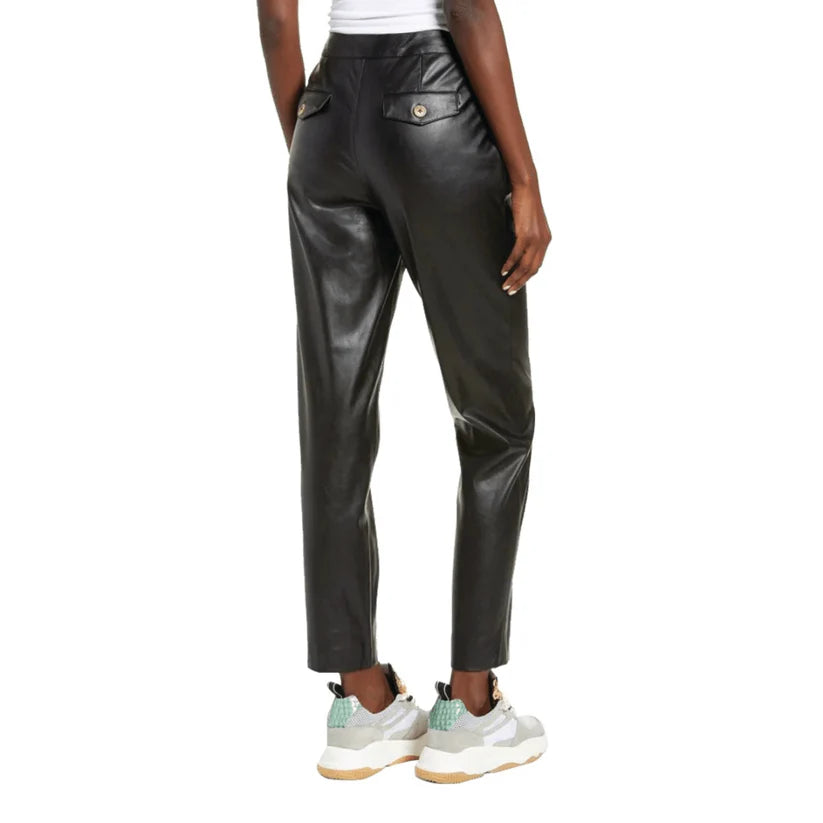 Black leather pants worn by a person on a white background