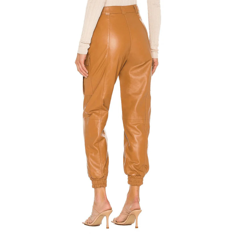 Tan leather jogger pants worn by a person on a white background